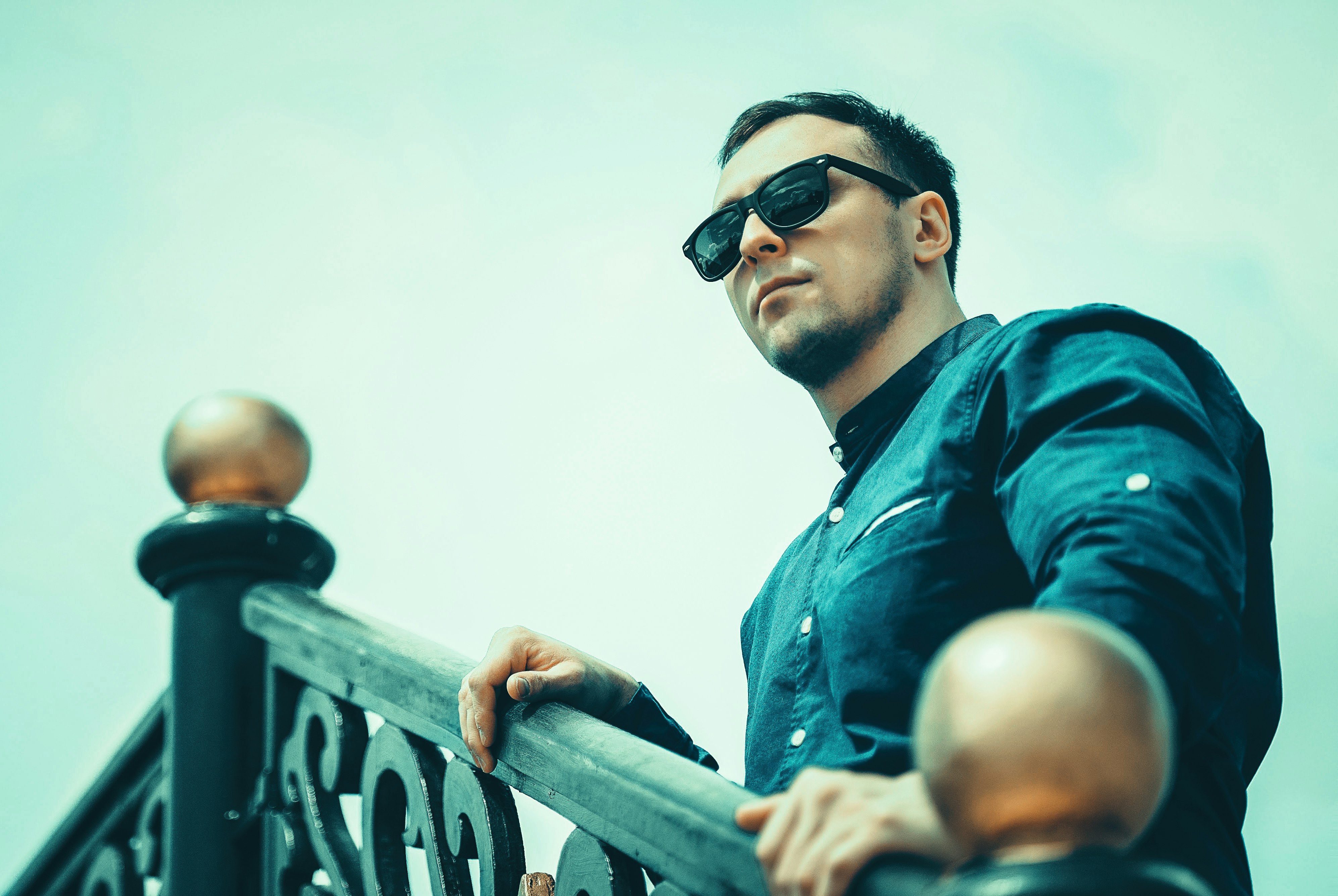 man in blue and black jacket wearing black sunglasses